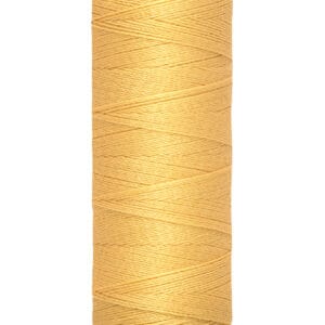 A spool of Gütermann sewing thread in a light orange color. The spool shows "100 m - 110 yds" printed on the bottom and is designed for universal use. The thread is neatly wound in a cylindrical shape.