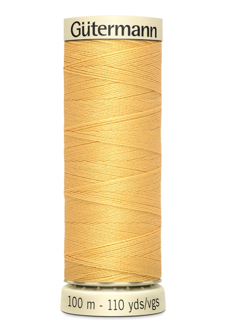 A spool of Gütermann sewing thread in a light orange color. The spool shows "100 m - 110 yds" printed on the bottom and is designed for universal use. The thread is neatly wound in a cylindrical shape.