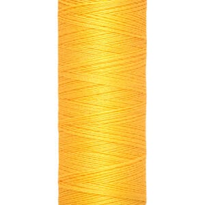 A spool of Gütermann polyester thread in bright orange. The label indicates a length of 100 meters or 110 yards.