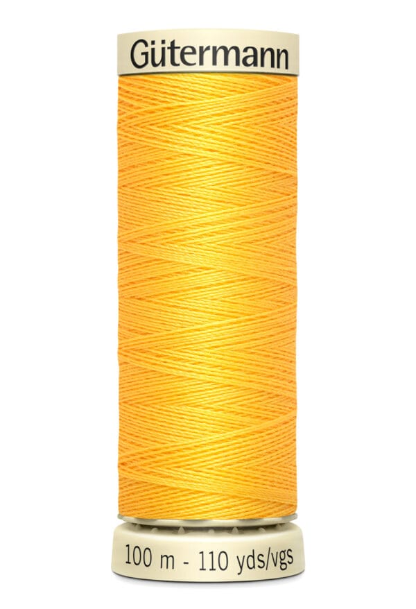 A spool of Gütermann polyester thread in bright orange. The label indicates a length of 100 meters or 110 yards.
