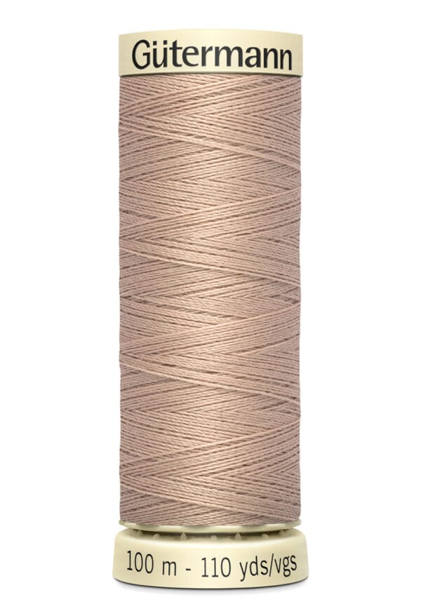 A spool of Gütermann sewing thread in a light brown color, labeled "100 m - 110 yds." The spool is upright with visible thread patterns wrapped around it.