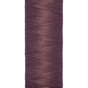 A spool of Gütermann thread in dark purple, labeled with "Gütermann" at the top. The bottom label indicates a length of 100 meters or 110 yards.