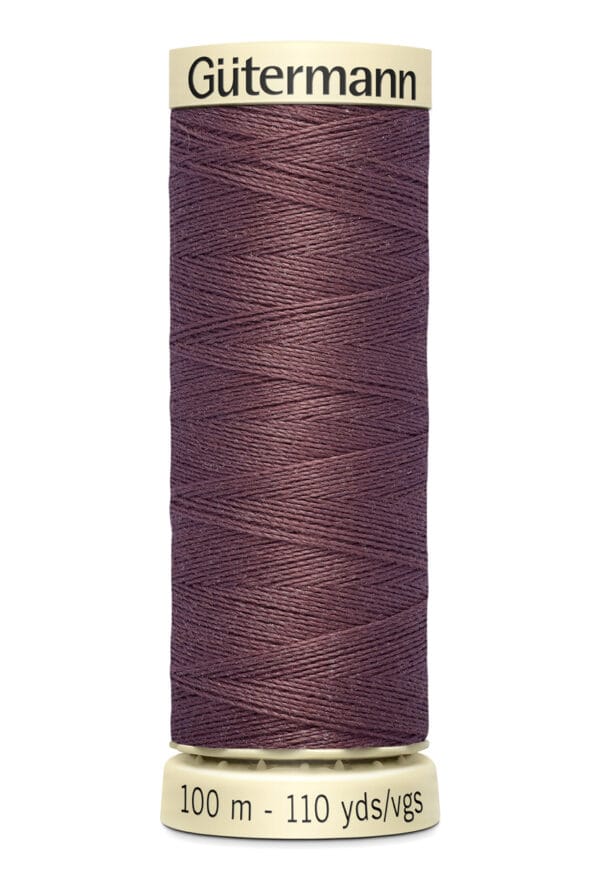 A spool of Gütermann thread in dark purple, labeled with "Gütermann" at the top. The bottom label indicates a length of 100 meters or 110 yards.