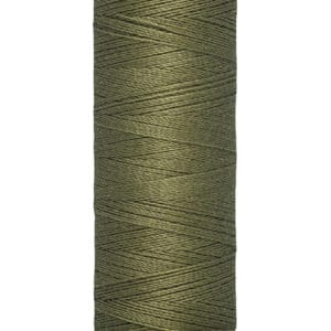A spool of Gütermann green sewing thread is displayed vertically. The label indicates 100 meters (110 yards) of thread. The spool is beige, and the thread is neatly wound.