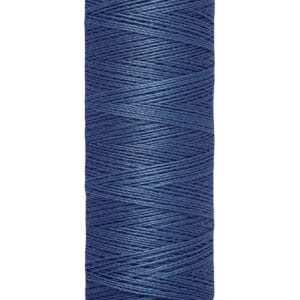 A spool of Gütermann dark blue sewing thread, labeled as 100 meters or 110 yards. The spool has a cream-colored top and base.