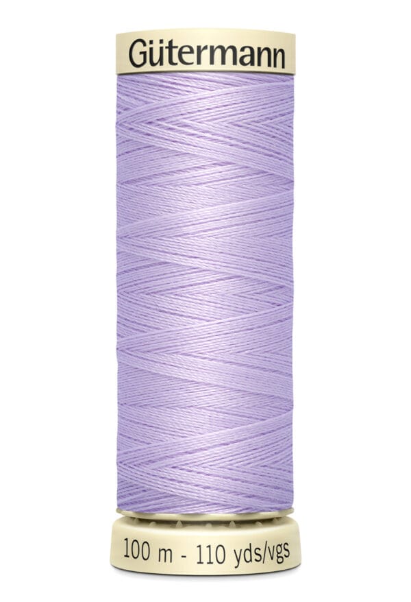 A spool of Gütermann sewing thread in light purple. The label indicates it is 100 meters or 110 yards long. The thread is tightly wound around a cream-colored spool.