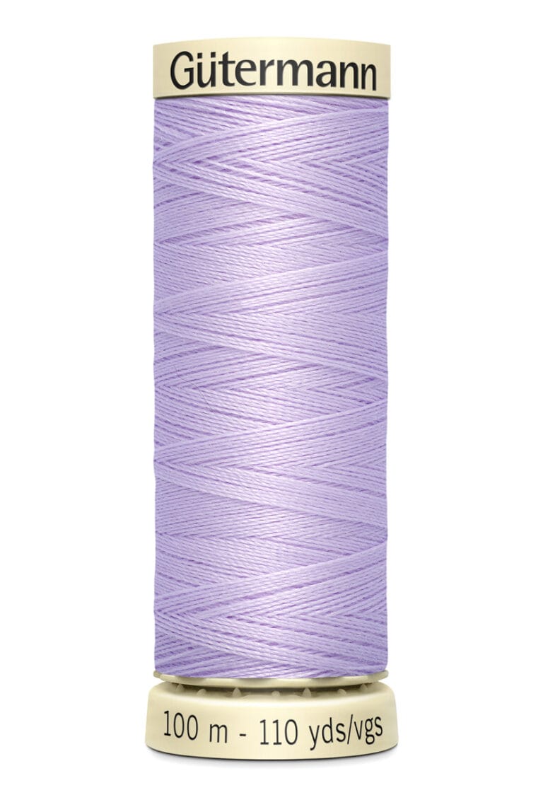 A spool of Gütermann sewing thread in light purple. The label indicates it is 100 meters or 110 yards long. The thread is tightly wound around a cream-colored spool.