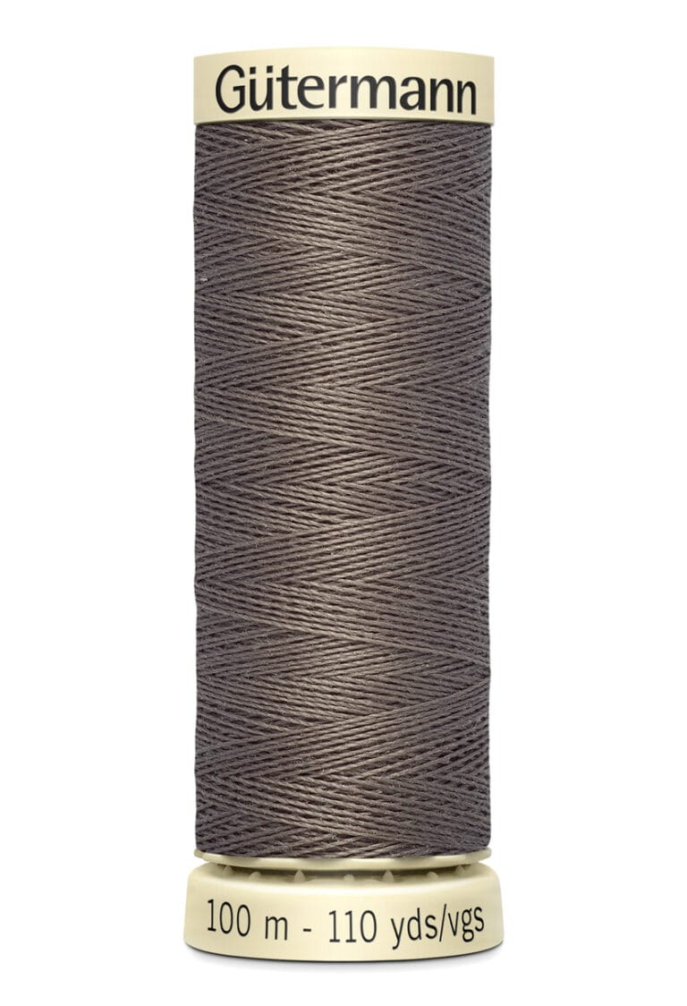 A spool of Gütermann thread in a dark taupe color, labeled with 100 meters and 110 yards. The spool is upright with cream-colored top and bottom caps.