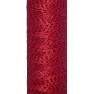 A spool of Gütermann red thread with 100 meters or 110 yards of material. The spool has a cream-colored top and bottom with black text stating the brand and length.