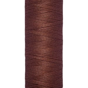 Spool of Gütermann brown thread, 100 meters (110 yards), on a beige holder.