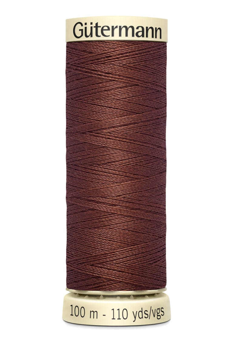 Spool of Gütermann brown thread, 100 meters (110 yards), on a beige holder.