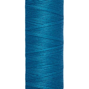 A spool of Gütermann thread in vibrant blue. The spool holds 100 meters (110 yards) of thread. The ends of the spool are cream-colored, and the brand name is printed on the top.