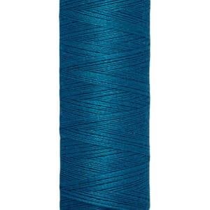 A spool of Gütermann blue sewing thread, labeled as 100 meters or 110 yards, with cream-colored ends.