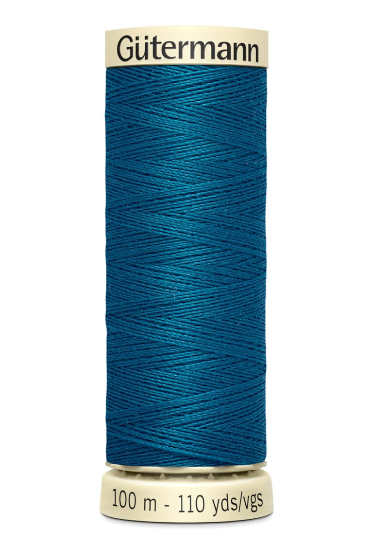 A spool of Gütermann blue sewing thread, labeled as 100 meters or 110 yards, with cream-colored ends.