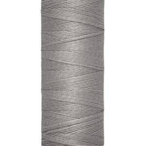 A spool of Gütermann gray sewing thread is shown vertically. The label reads "100 m - 110 yds/vgs." The thread is neatly wound around the spool, which is cream-colored at both ends.