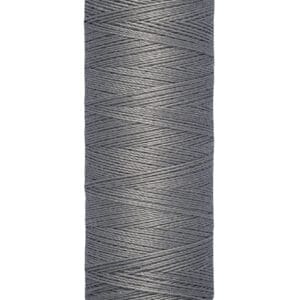 A spool of Gütermann gray sewing thread, 100 meters or 110 yards, with beige ends.