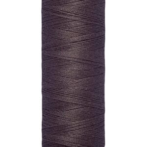 A spool of Gütermann sewing thread in dark purple, labeled with "100 m - 110 yds" at the base.