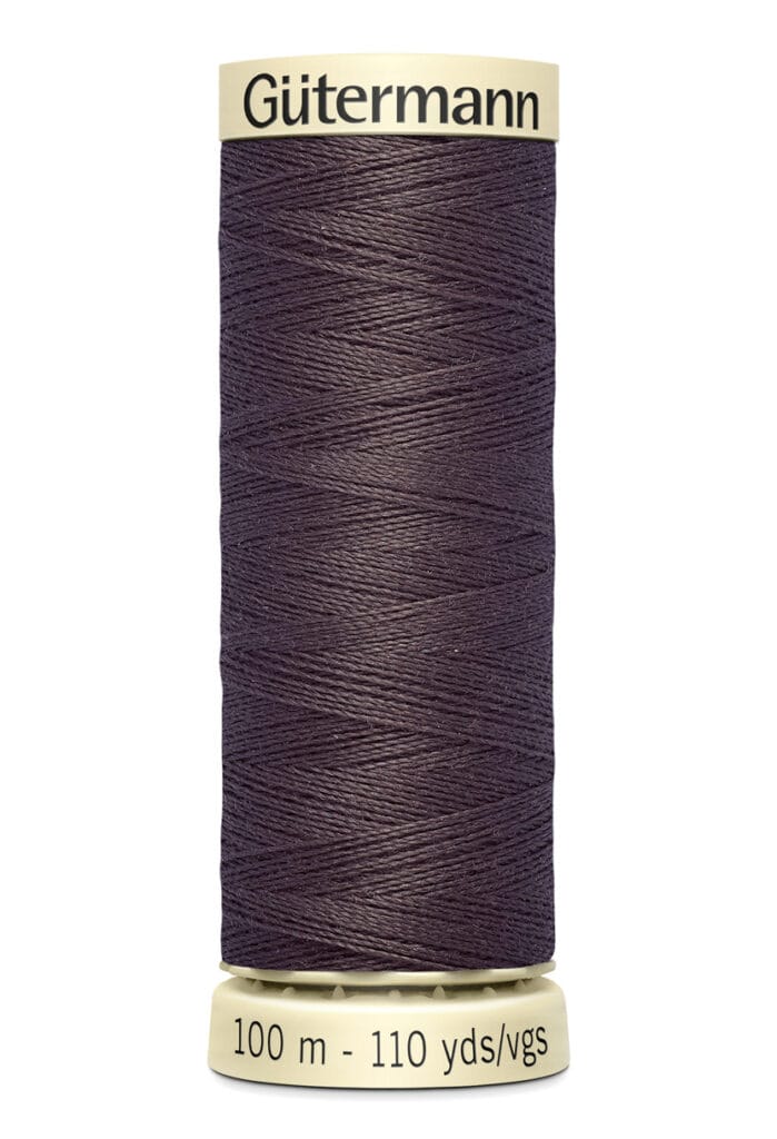 A spool of Gütermann sewing thread in dark purple, labeled with "100 m - 110 yds" at the base.