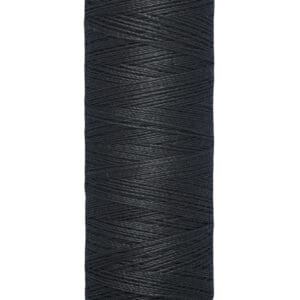 A spool of Gütermann black sewing thread, labeled with "100 m - 110 yds/vgs" on the bottom and "Gütermann" on top, features tightly wound thread on a cylindrical spool with a beige top and base.