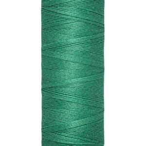 A spool of Gütermann green sewing thread with a label indicating 100 meters or 110 yards.