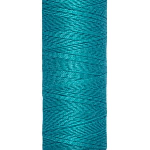 A spool of Gütermann thread in vibrant teal color, labeled with "100 m - 110 yds/vgs" on a beige base. The thread is neatly wound around the spool.