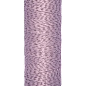 A spool of lilac-colored Gütermann sewing thread with a cream base and top. The label indicates a length of 100 meters or 110 yards.