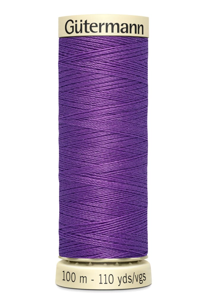 A spool of Gütermann sewing thread in vibrant purple. The cylindrical spool is labeled with "Gütermann" at the top and shows the length as 100 meters or 110 yards at the base.