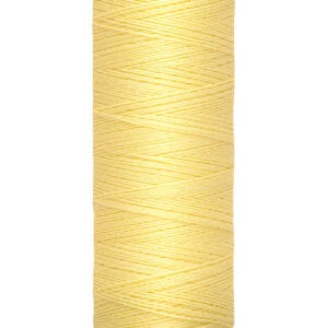 A spool of Gütermann sewing thread with pale yellow color. The label indicates 100 meters, 110 yards.