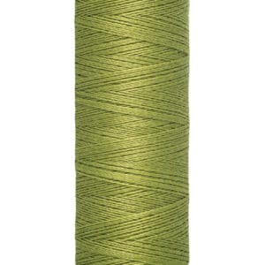 A spool of Gütermann thread in light green, wrapped neatly around the spool. The label indicates 100 meters or 110 yards. The top and bottom of the spool are cream-colored.