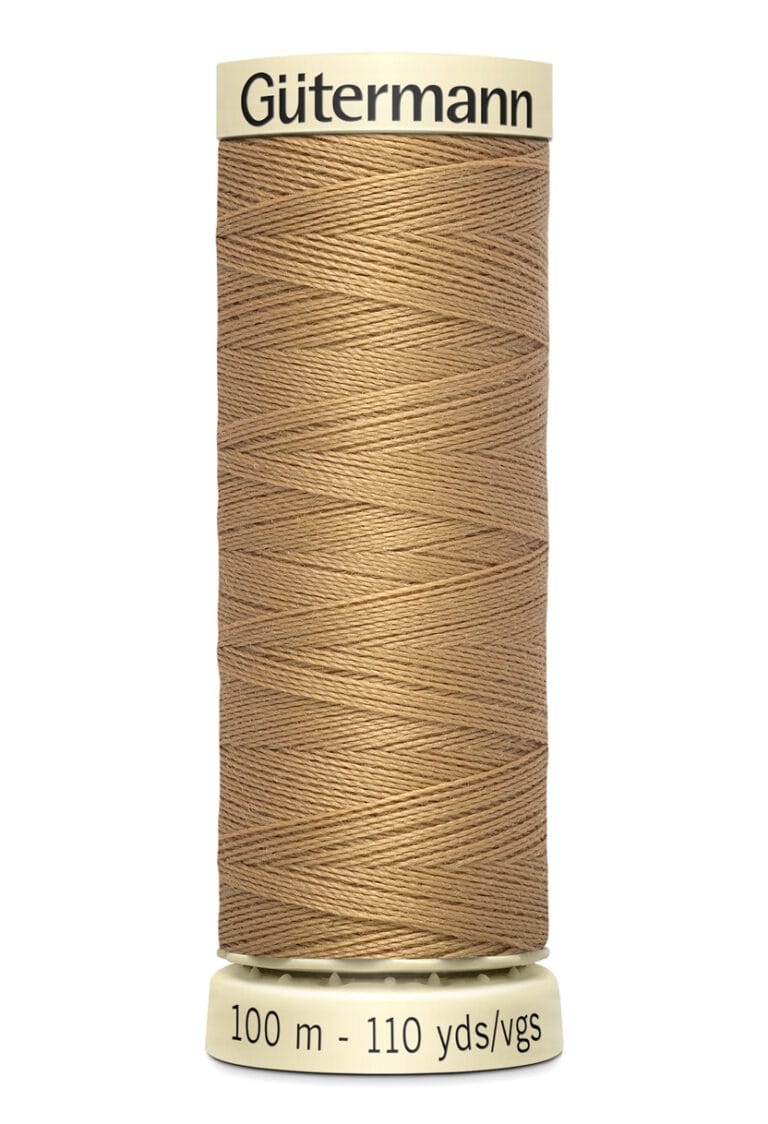 A spool of Gütermann sewing thread in a light brown color, labeled for 100 meters and 110 yards. The thread is neatly wound around the spool, with a cream-colored base and top.