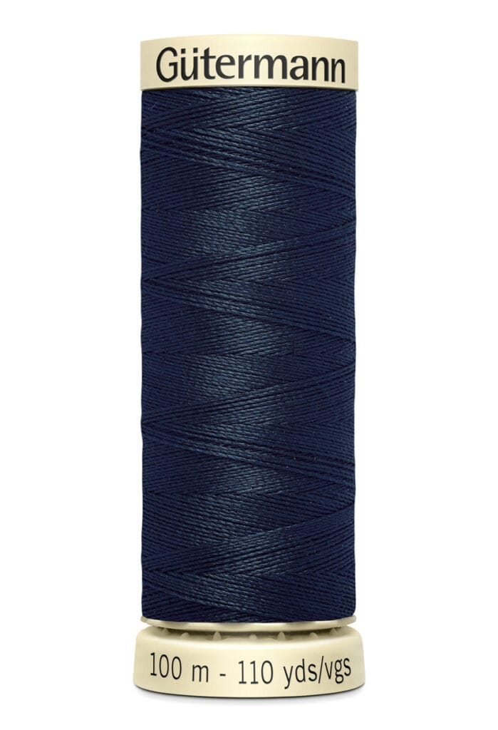 A spool of Gütermann dark blue sewing thread. The spool holds 100 meters or 110 yards of thread, with a beige label on top and bottom displaying the brand name and length information.