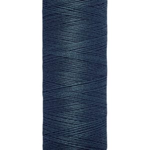 A spool of Gütermann thread in dark blue. The label reads "100 m - 110 yds/vgs" and the spool has a beige base and top.