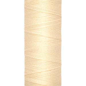 A spool of Gütermann thread in a light cream color, labeled with 100 meters or 110 yards. The thread is neatly wound on a beige plastic spool.