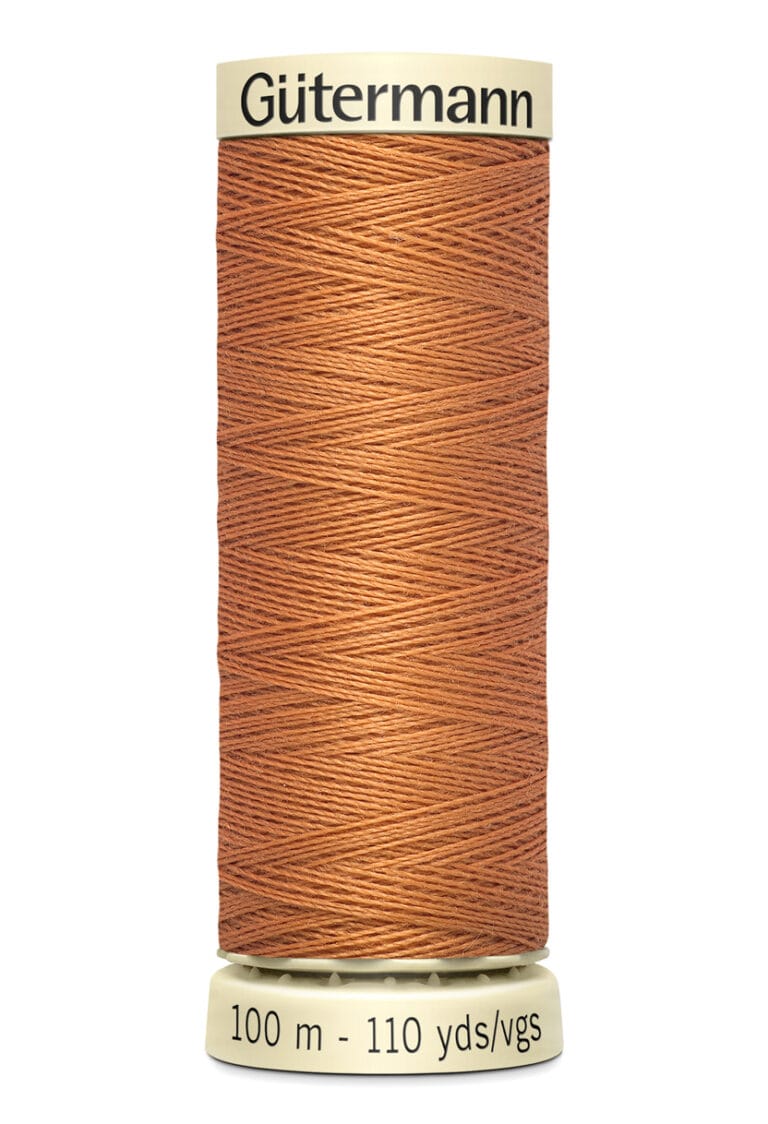 A spool of Gütermann sewing thread in a warm brown color. The label displays "100 m - 110 yds/vgs.