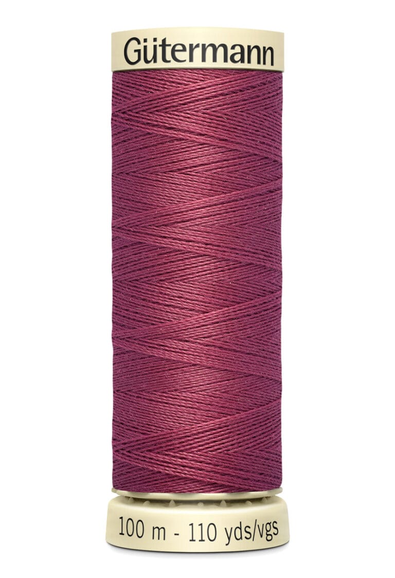 A spool of Gütermann thread with a burgundy color. The label indicates it contains 100 meters or 110 yards of thread. The spool is cylindrical with cream-colored ends and the brand name is printed on the top edge.