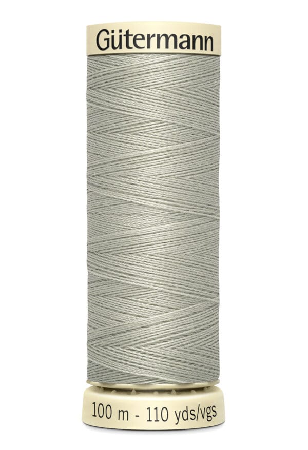 Spool of Gütermann sewing thread with light gray color, displaying text "100 m - 110 yds/vgs" at the base.