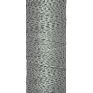 A spool of Gütermann sewing thread in a light gray color, with 100 meters (110 yards) indicated on the label. The spool is cylindrical and the label is cream-colored with black text.