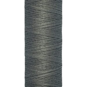 A spool of Gütermann sewing thread, gray in color, labeled with 100 meters and 110 yards. The spool is upright, and the thread is neatly wound.