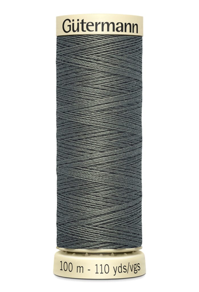 A spool of Gütermann sewing thread, gray in color, labeled with 100 meters and 110 yards. The spool is upright, and the thread is neatly wound.