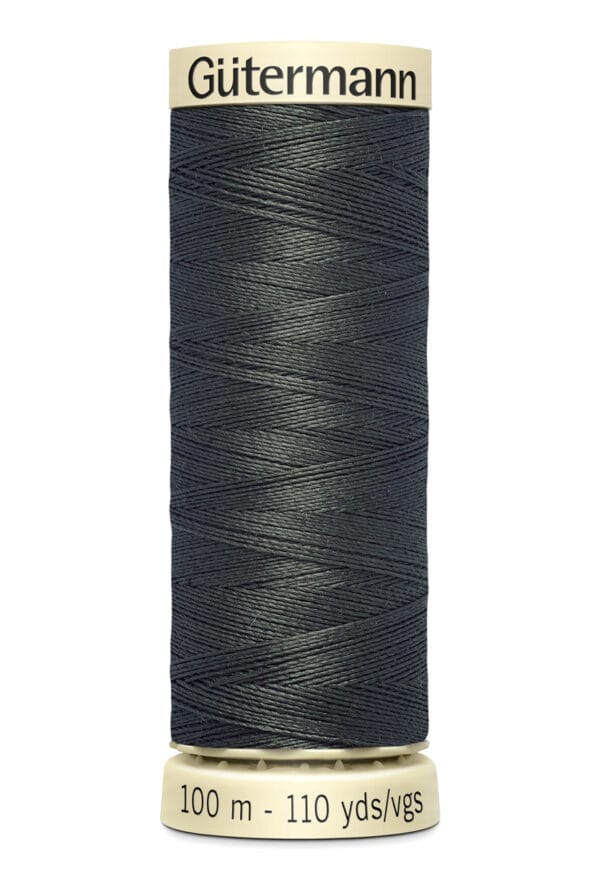 A spool of Gütermann polyester sewing thread, dark gray in color, with a length of 100 meters or 110 yards. The spool has beige labels at the top and bottom.