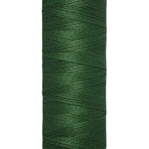 A spool of Gütermann green thread, labeled with "100 m - 110 yds/vgs." The thread is neatly wound on a beige spool.