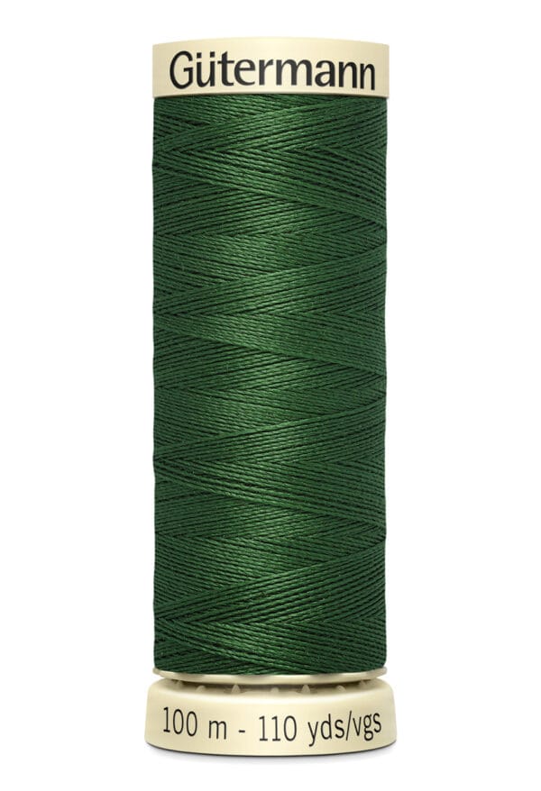 A spool of Gütermann green thread, labeled with "100 m - 110 yds/vgs." The thread is neatly wound on a beige spool.