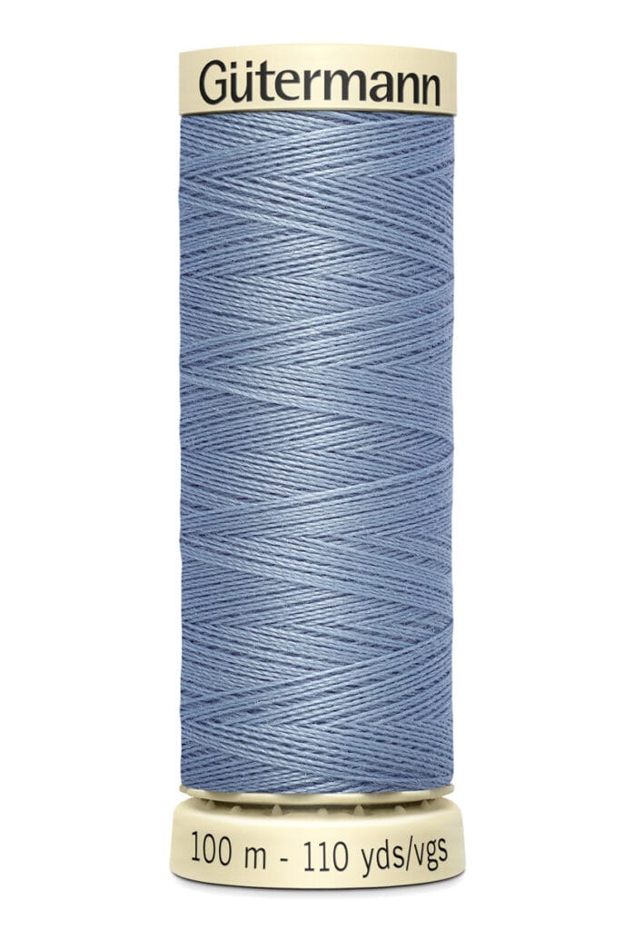 A spool of Gütermann sewing thread in light blue, wrapped around a beige cylinder. The label indicates the length is 100 meters or 110 yards.