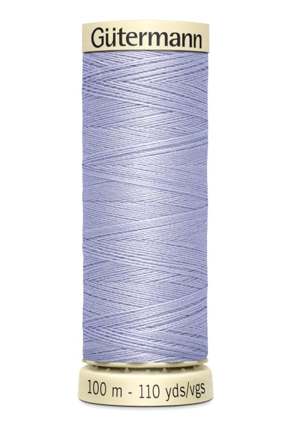 A spool of Gütermann sewing thread in light purple. The label indicates the length is 100 meters or 110 yards. The spool is cylindrical with beige ends, and the thread is neatly wound around it.