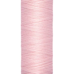 A spool of Gütermann sewing thread in light pink, featuring a cream-colored label. The label displays the brand name at the top and indicates 100 meters or 110 yards of thread at the bottom.