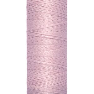 A spool of Gütermann sewing thread in light pink, showing 100 meters or 110 yards on the label, with a cream-colored top and base.