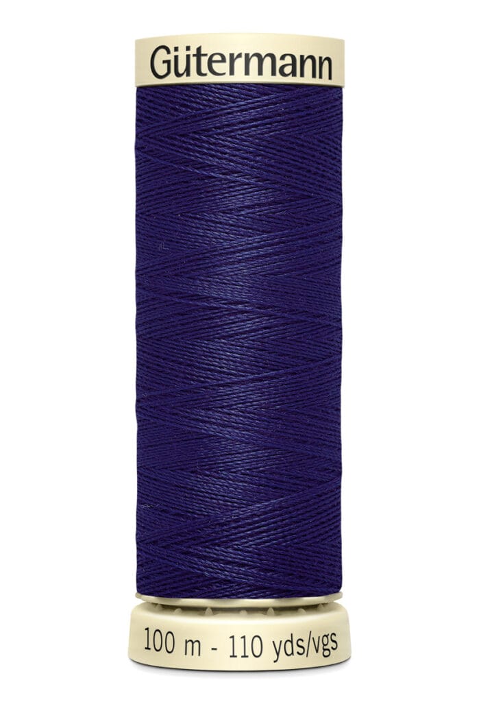 Spool of Gütermann thread in deep blue, labeled with "100 m - 110 yds" on the bottom and brand name on top.