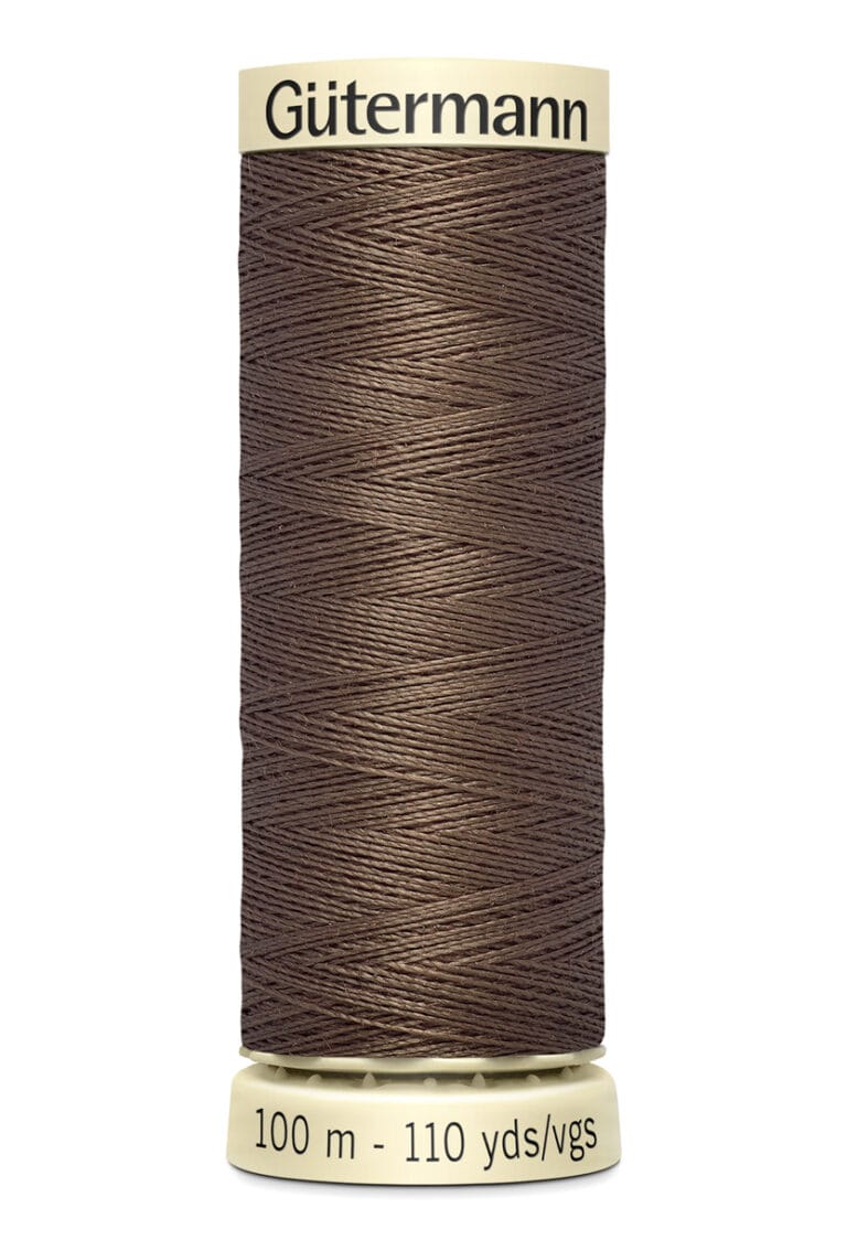 A spool of Gütermann thread with brown thread wound around it. The spool displays the length as 100 meters or 110 yards.