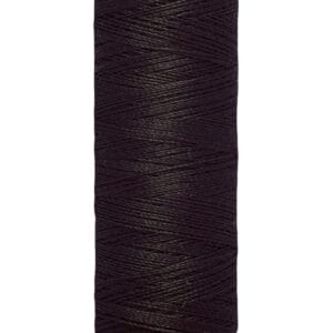A spool of Gütermann sewing thread in dark brown. The spool is labeled with "Gütermann" at the top and "100 m - 110 yds/vgs" at the bottom. The thread is tightly wound around the beige spool.