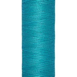 A spool of Gütermann sewing thread in bright turquoise. The spool's label is beige, indicating 100 meters or 110 yards. The thread is tightly wound around the spool, showcasing its vibrant color.